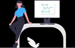 A woman leaning on a desk with a computer displaying generic code